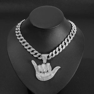 Iced out silver Shaka 666 gesture pendant with Cuban chain on a black bust display
