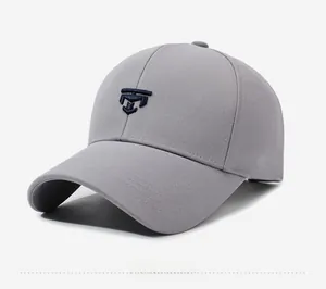 Detail view of grey cotton baseball cap showing navy blue embroidery and curved visor
