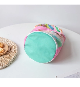 Close-up of the round base and colorful canvas stitching of the cartoon bucket bag