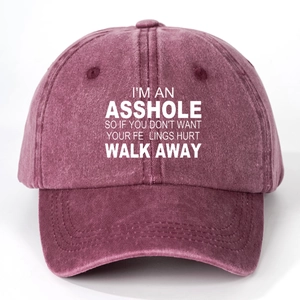 Close-up of vintage washed burgundy cotton baseball cap with white printed typography
