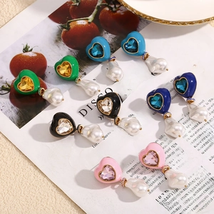 Detail of heart earrings with baroque pearls and colorful crystals in five colors