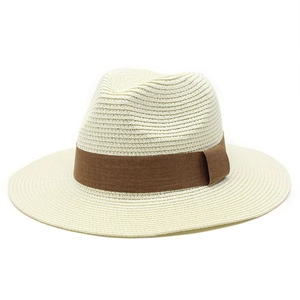 Detailed close-up of woven paper straw texture and brown fabric band on Panama hat