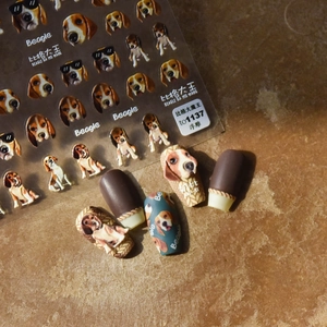 3D embossed Beagle dog nail stickers with detailed patterns on warm stone background