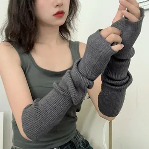 Close-up of long dark grey ribbed knit arm warmers with fingerless design for women
