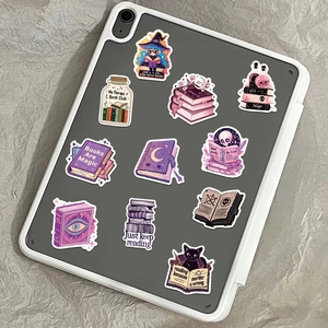 Gothic Magic Bookish Witch stickers set displayed on a tablet case with purple accents