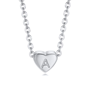 Detailed macro view of polished silver heart necklace pendant with letter A engraving