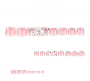 Detail of pink French toenail tips with 3D resin flowers, pearls and rhinestones