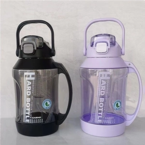 Macro shot of large sports water bottles in black and purple with carry handles and straws