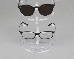 Close-up of transparent acrylic multi-tier glasses display rack with various sunglasses