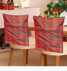 Detail of red plaid fabric Christmas chair covers for festive American style dining decor