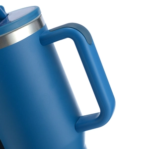 Close-up of the ergonomic blue plastic handle and metallic rim on the insulated tumbler