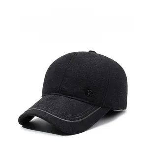 Detailed view of dark grey winter baseball cap with plush ear flaps and metal R logo