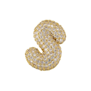 Macro shot of gold-plated S-letter pendant fully encrusted with clear cubic zirconia stones