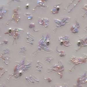 Macro detail of 3D embossed nail stickers with iridescent crane and pearl accents