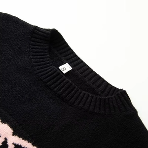Close-up of ribbed crewneck knit sweater with pink floral jacquard and S-size label