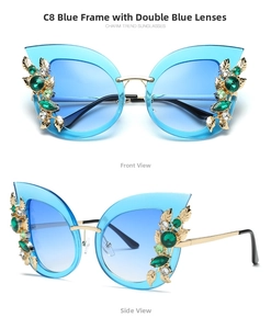 Detail view of blue cat-eye sunglasses with gold leaf and emerald gemstone accents