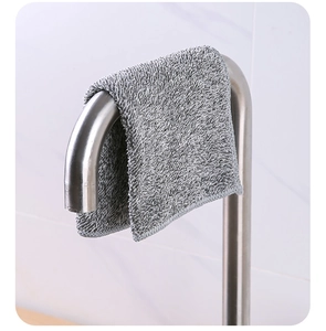 Close-up of a thick grey bamboo charcoal fiber cloth hanging on a faucet for dish cleaning