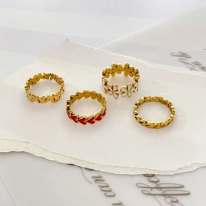 Cute gold ring set with red enamel heart, daisy flower, and hollow leaf patterns