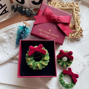 Detailed Christmas wreath brooch set in luxury red gift box with festive ribbon decoration