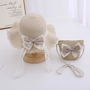 Detail view of straw sun hat and matching crossbody bag with lace bow for girls