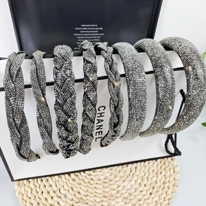 Detail of eight luxury braided and smooth rhinestone headbands in silver and black tones
