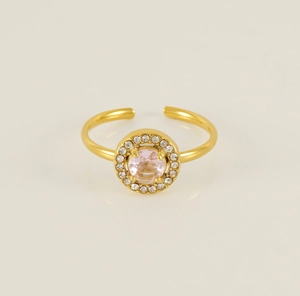 Close-up of gold titanium ring featuring a pink zircon center stone with four-prong setting