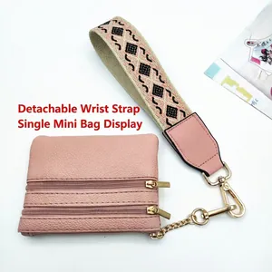 Pink phone strap with zipper pouch and patterned wristlet with gold hardware
