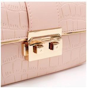 Close-up of pink crocodile texture leather and premium gold square metal lock buckle
