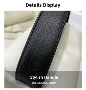 Macro shot of the woven V-shaped texture and fine stitching on the black handbag handle