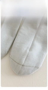 Detail of light grey cotton socks showing seamless toe stitching for maximum comfort
