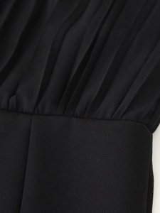 Macro shot of the pleated waist detail and stitching on this black chiffon dress
