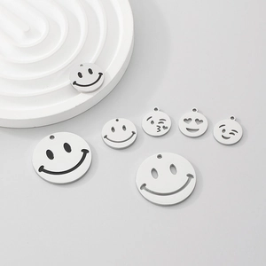 Macro shot of silver stainless steel smiley face charms with various emoji expressions