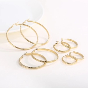 Three pairs of gold stainless steel hoop earrings with Greek fret and diamond cut textures