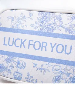 Close-up of Toile de Jouy floral pattern and LUCK FOR YOU text on the crossbody bag