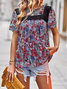Detail view of colorful floral print top featuring elegant black lace splicing on shoulders