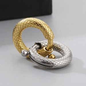 Detail of interlocking gold and silver textured spring clasps for jewelry making