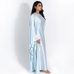 Detail view of light blue satin dress featuring elegant draped cape sleeves and silk texture