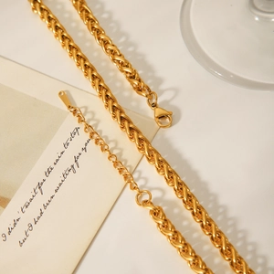 Detail of 18K gold-plated stainless steel woven necklace with secure lobster clasp