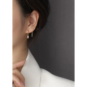 Close-up of gold S925 silver hoop earring with rectangular zircon and delicate chain