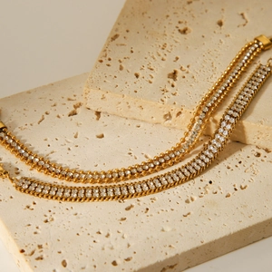 Macro detail of 18K gold stainless steel bracelets with double-layer white zircon inlay
