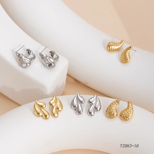 Detailed view of assorted gold and silver stainless steel earrings in textured designs