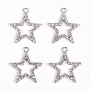 Detail of four silver star pendants with white rhinestones and hollow design