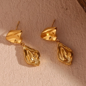 Macro shot of 18K gold plated stainless steel earrings with irregular geometric texture