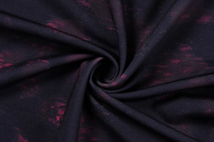 Detailed close-up of textured leopard print fabric showing soft dense knit structure