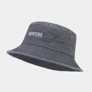 Detail of washed grey cotton bucket hat with white New York embroidery and metal eyelet