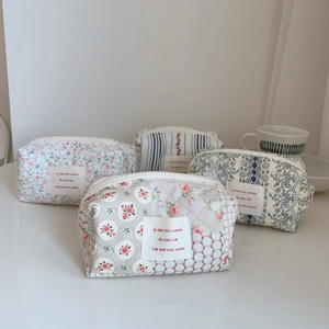 Quilted floral cotton cosmetic bags with zip closure and French text label