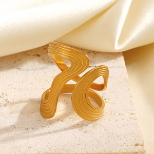 Minimalist gold wavy irregular ring with brushed texture on aesthetic beige stone