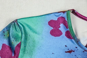 Detail of round neckline and shoulder stitching on retro pleated printed A-line dress