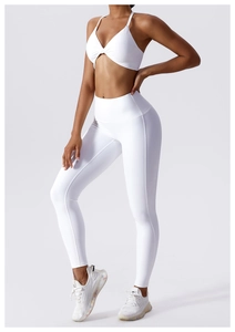 Close-up of white yoga set featuring cross-pleated sports bra and high-waist leggings