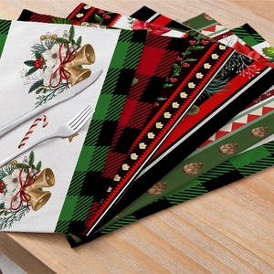 Christmas cotton linen placemats with holly and bells on light wood table